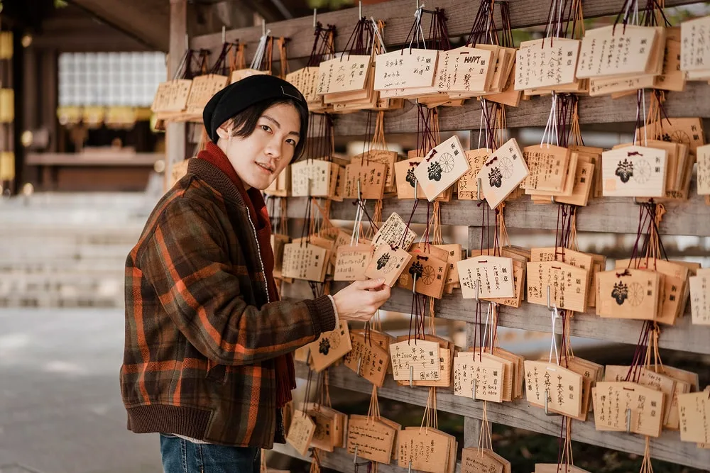 man-looking-japanese-wooden-cards-min.webp